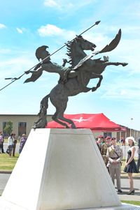 Showing HRH Prince Charles the bronze of 'Pegasus and Bellerophon' the reinstated insignia of the Airborne Forces
